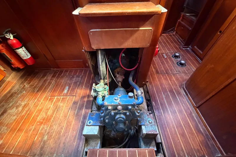 Slide: The Image of 1983 Morgan Catilina engine room with wooden flooring and visible fire extinguisher. - 130