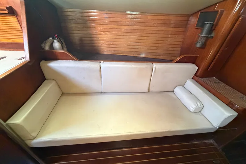 Slide: The Image of 1983 Morgan Catilina interior with white cushioned seating and wooden paneling. - 134