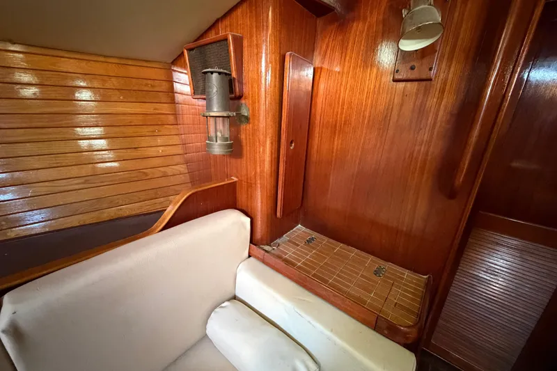 Slide: The Image of 1983 Morgan Catilina yacht interior with wooden paneling and cozy seating area. - 136