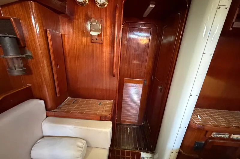 Slide: The Image of Interior of 1983 Morgan Catilina yacht with wooden paneling and seating area. - 137