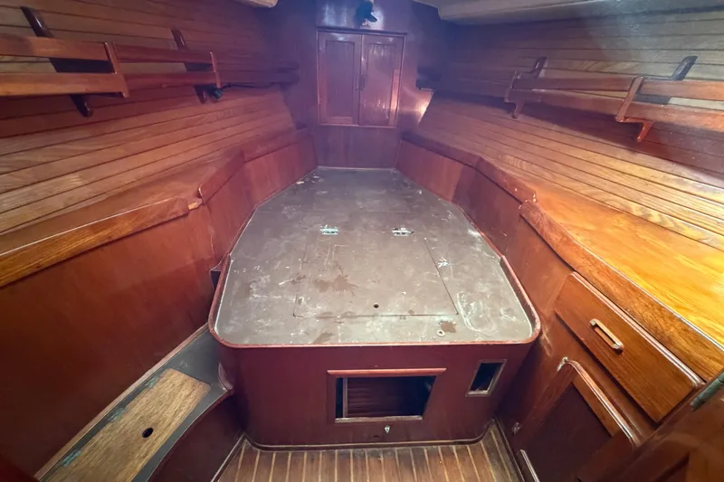 Slide: The Image of 1983 Morgan Catilina boat interior with wooden paneling and storage shelves. - 149