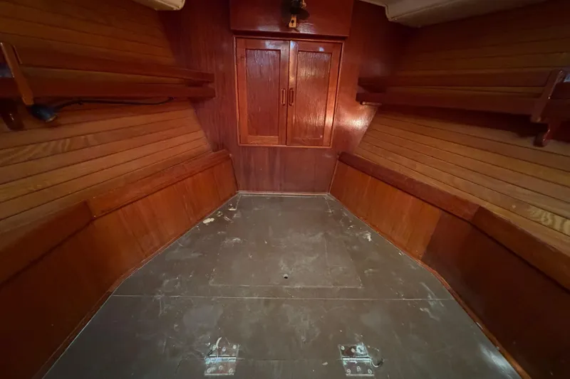 Slide: The Image of Interior of 1983 Morgan Catilina boat with wooden paneling and storage shelves. - 152
