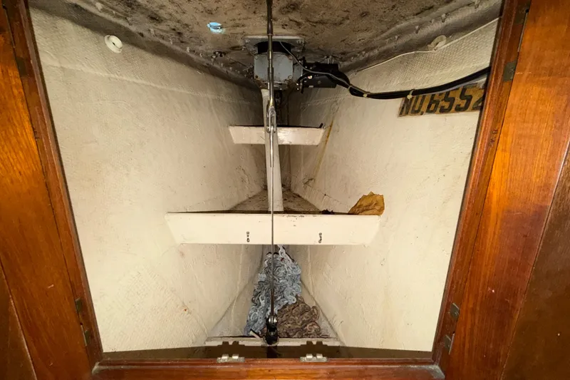Slide: The Image of Interior view of a 1983 Morgan Catilina sailboat compartment with mechanical components. - 160