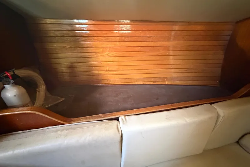 Slide: The Image of Interior of a 1983 Morgan Catilina boat with wooden paneling and seating. - 165