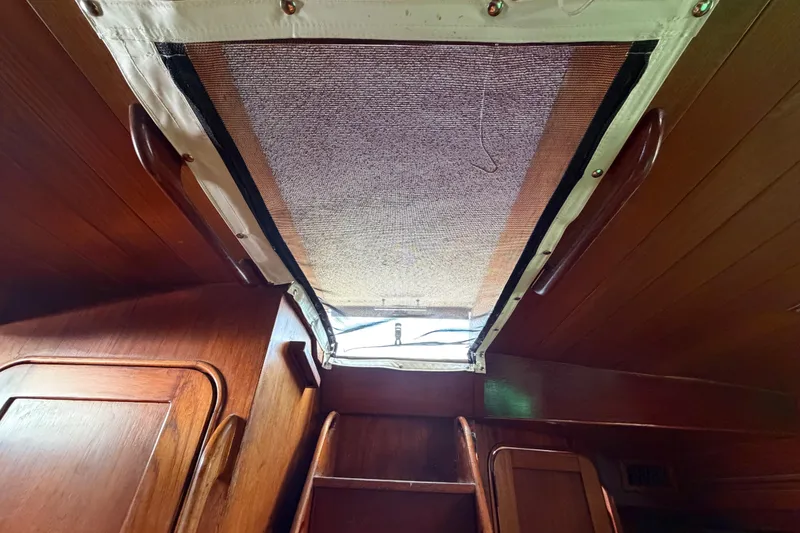 Slide: The Image of Interior view of 1983 Morgan Catilina sailboat with wooden cabinetry and ceiling hatch. - 168