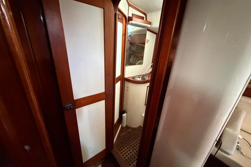 Slide: The Image of 1983 Morgan Catilina yacht interior with wooden doors and compact bathroom. - 175