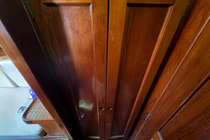 Slide: The Image of Wooden interior of a 1983 Morgan Catilina boat, featuring polished cabinet doors. - 177