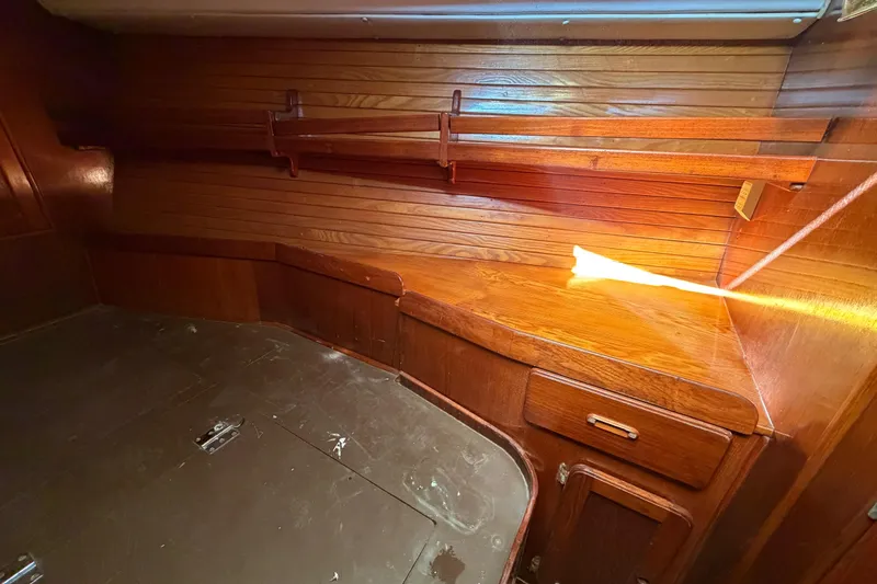 Slide: The Image of 1983 Morgan Catilina interior with wooden cabinetry and shelving, showcasing classic nautical design. - 181