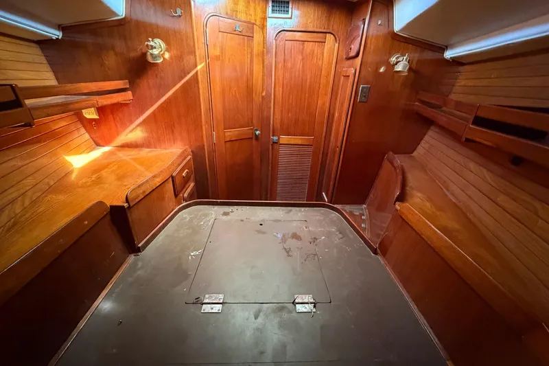 Slide: The Image of 1983 Morgan Catilina yacht interior with wooden cabinetry and storage compartments. - 191