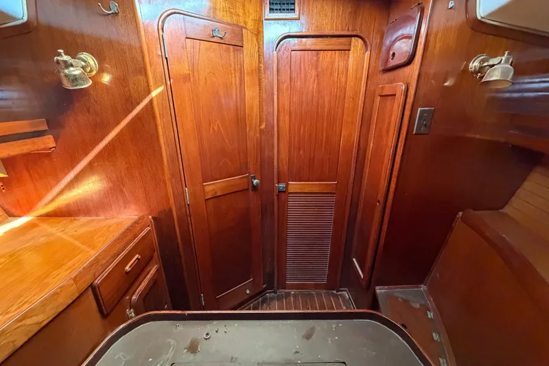 Slide: The Image of 1983 Morgan Catilina yacht interior with wooden cabinetry and warm lighting. - 192