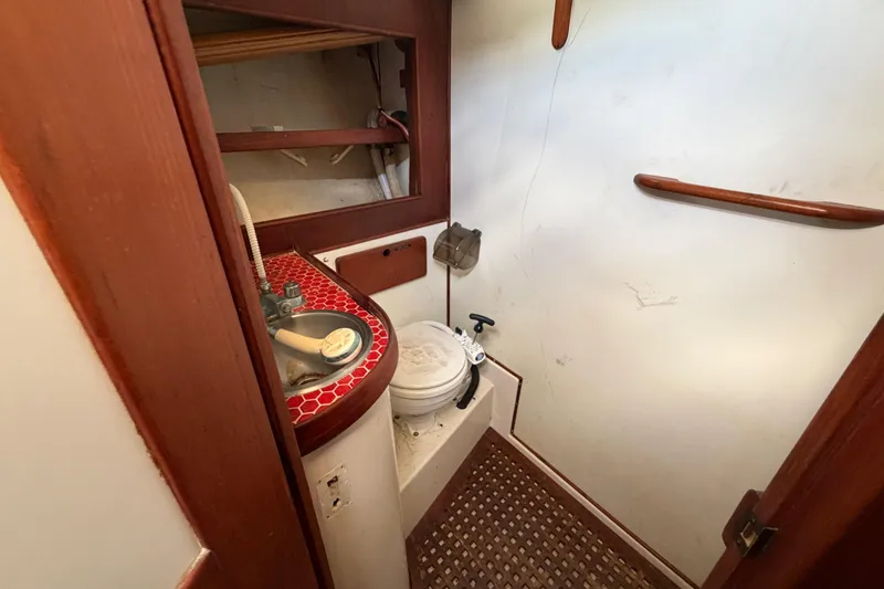 Slide: The Image of 1983 Morgan Catilina boat bathroom with red-tiled sink and compact toilet. - 194