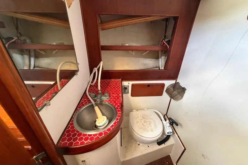 Slide: The Image of 1983 Morgan Catilina boat bathroom with red-tiled sink and compact toilet. - 195