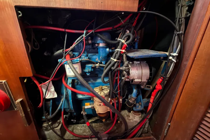 Slide: The Image of Engine compartment of a 1983 Morgan Catilina, featuring wiring and mechanical components. - 198