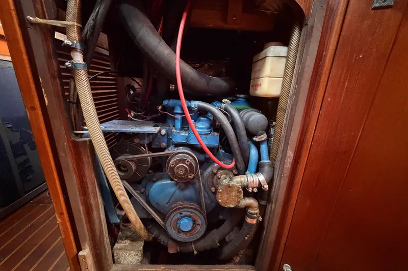Slide: The Image of 1983 Morgan Catilina engine compartment with visible hoses and components. - 200