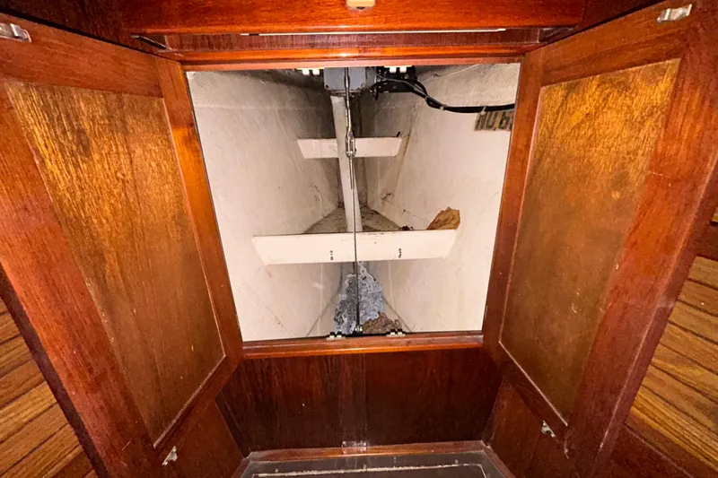 Slide: The Image of Interior view of 1983 Morgan 45 Catalina sailboat storage compartment with wooden doors. - 203