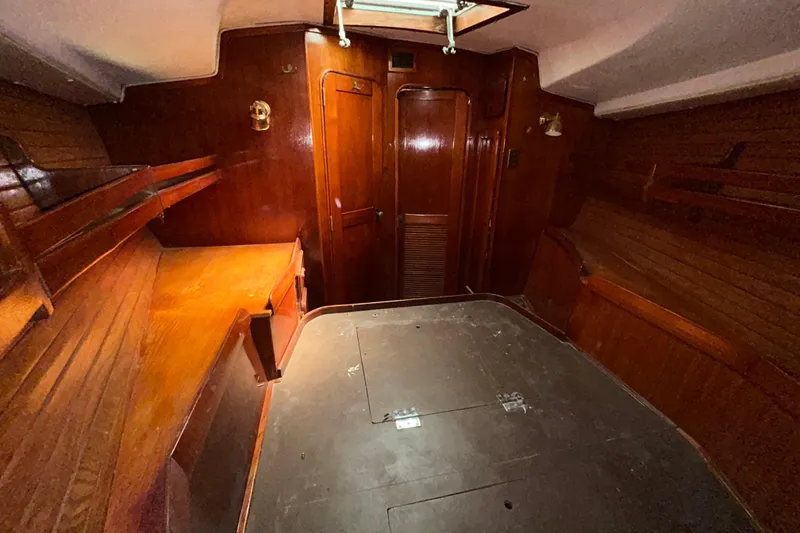 Slide: The Image of Interior of 1983 Morgan 45 Catalina sailboat with wooden paneling and built-in shelves. - 204