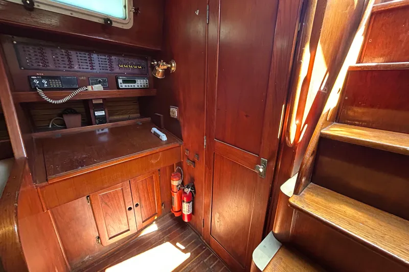 Slide: The Image of Interior of 1983 Morgan 45 Catalina sailboat with wooden cabinetry and navigation equipment. - 205