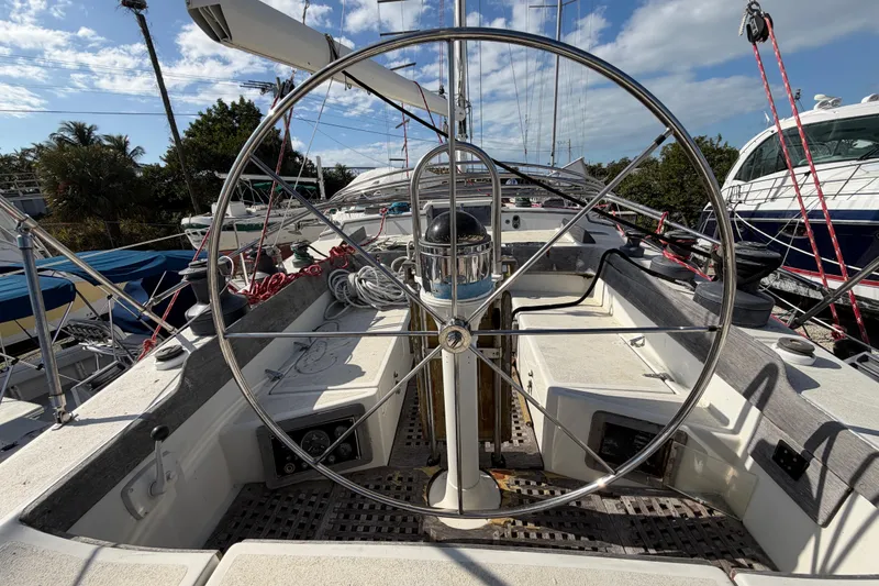 Slide: The Image of 1983 Morgan Catilina sailboat cockpit with large steering wheel and nautical equipment. - 21