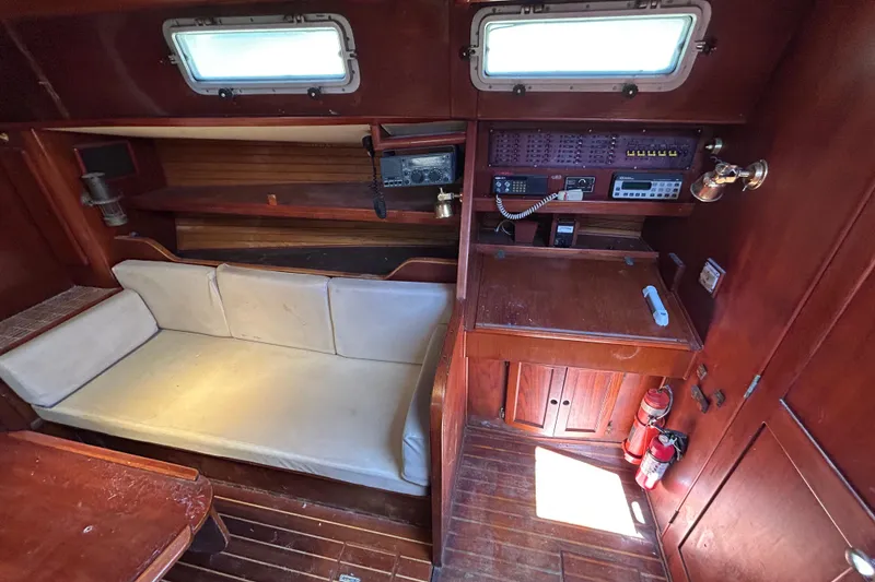 Slide: The Image of Interior of 1983 Morgan 45 Catalina yacht with wooden furnishings and navigation equipment. - 215