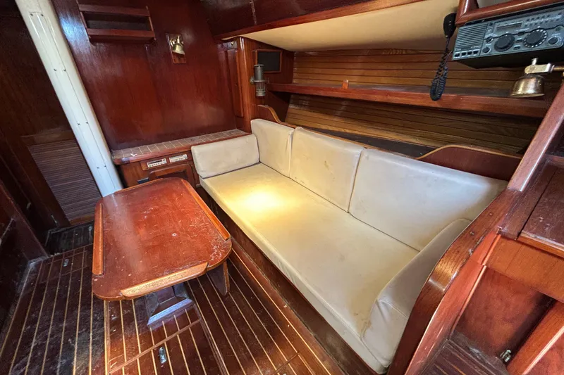 Slide: The Image of Interior of 1983 Morgan 45 Catalina sailboat with wooden furnishings and beige seating. - 216