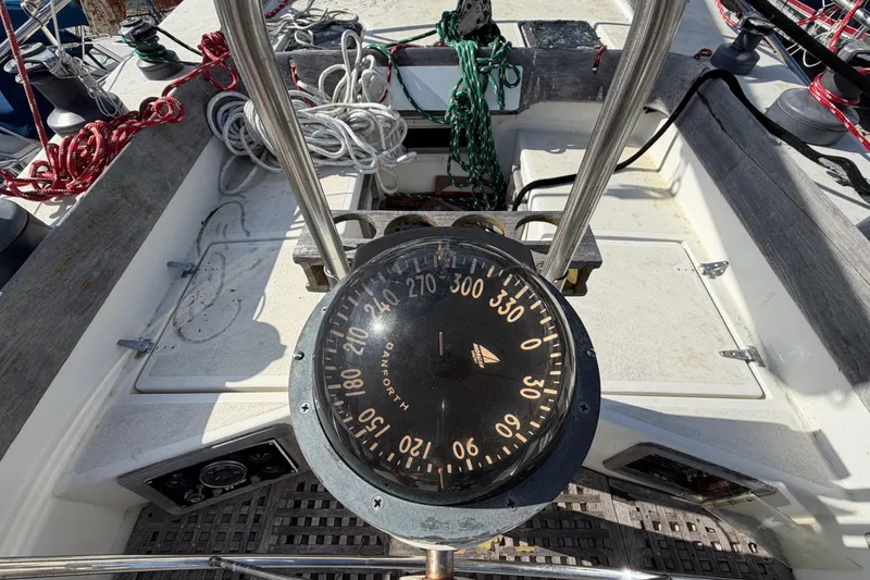 Slide: The Image of Compass on 1983 Morgan Catilina sailboat deck with ropes and equipment. - 22