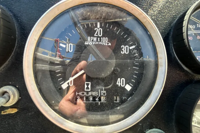 Slide: The Image of Close-up of a 1983 Morgan 45 Catalina tachometer, showing RPM and engine hours. - 220