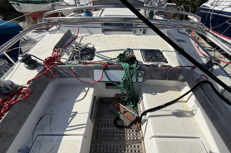 Slide: The Image of Cockpit of 1983 Morgan Catilina sailboat with ropes and winches, docked in a marina. - 27
