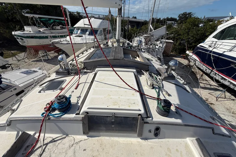 Slide: The Image of 1983 Morgan Catilina sailboat deck with ropes and winches in a boatyard. - 30