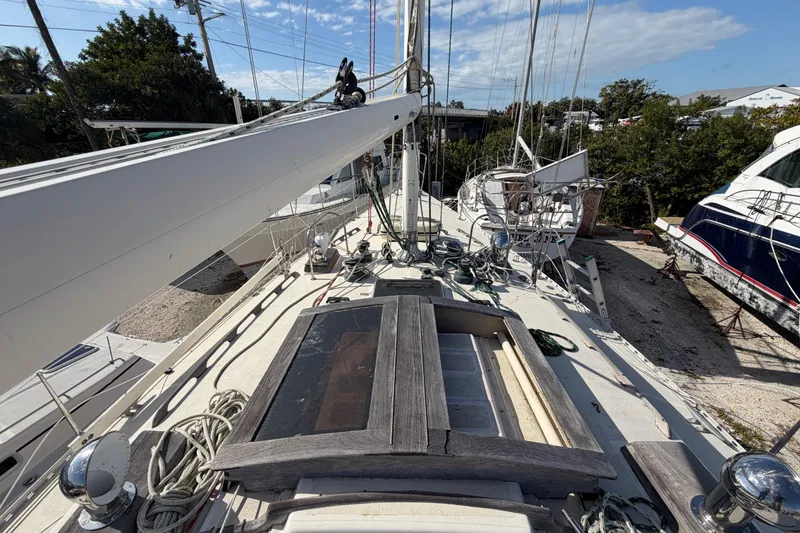 Slide: The Image of 1983 Morgan Catilina sailboat deck with rigging and equipment, docked under a clear sky. - 33