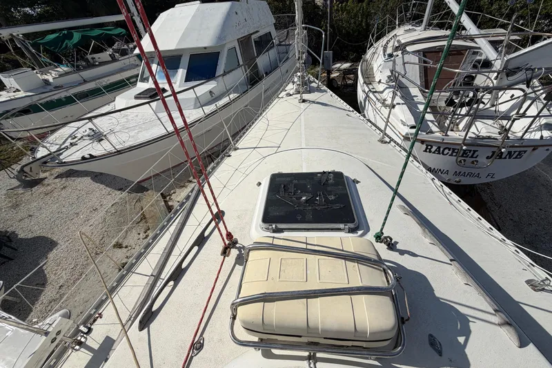 Slide: The Image of 1983 Morgan Catilina sailboat deck with nearby boats in a marina setting. - 36