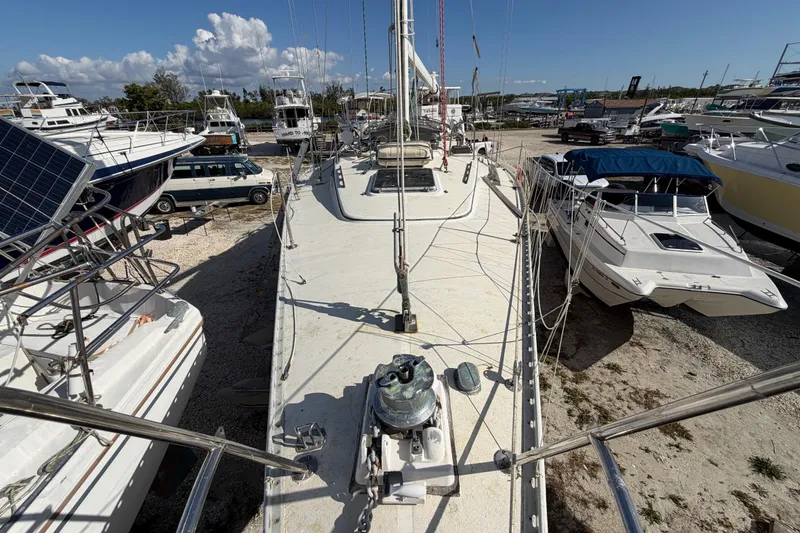 Slide: The Image of 1983 Morgan Catilina sailboat on dry dock surrounded by other boats under a clear sky. - 41