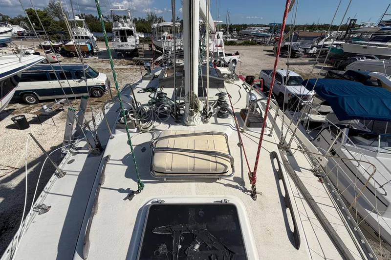 Slide: The Image of 1983 Morgan Catilina sailboat deck with ropes and equipment in a marina. - 45