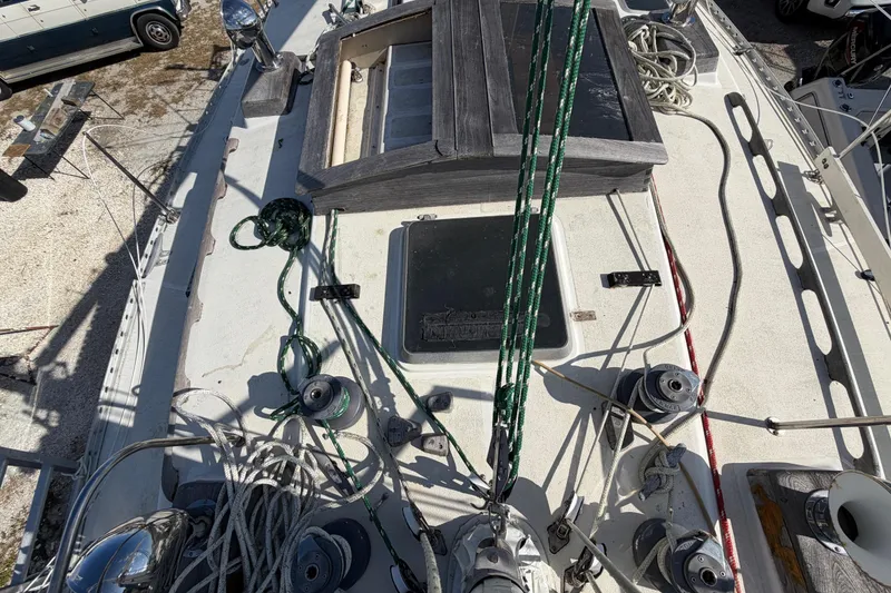 Slide: The Image of Deck of 1983 Morgan Catilina sailboat with ropes and winches visible. - 46