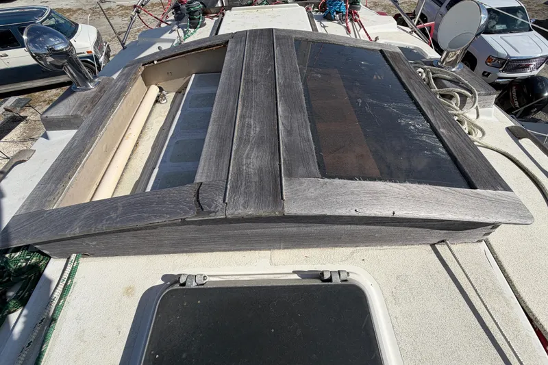 Slide: The Image of 1983 Morgan Catilina yacht deck with wooden hatch and nautical equipment. - 48