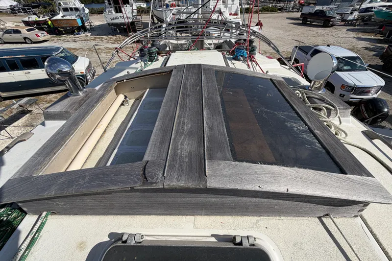 Slide: The Image of 1983 Morgan Catilina yacht deck with wooden hatch and surrounding marina. - 49