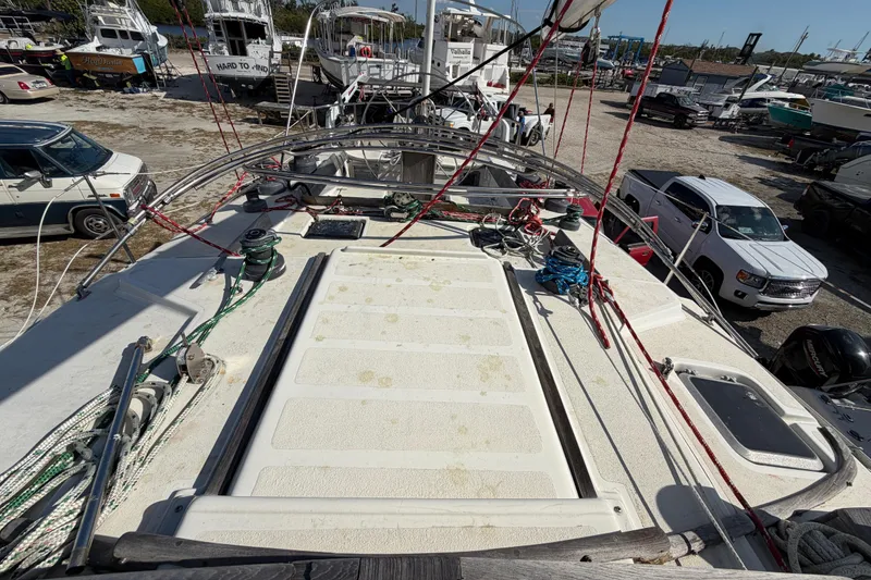 Slide: The Image of 1983 Morgan Catilina sailboat deck with ropes and winches in a boatyard. - 51