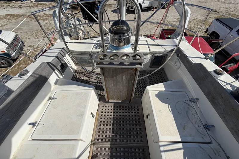Slide: The Image of 1983 Morgan Catilina boat cockpit with steering wheel and storage compartments. - 57