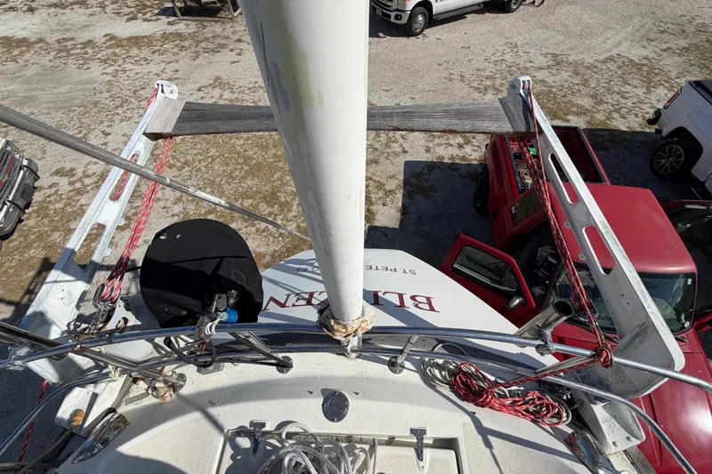 Slide: The Image of Top view of 1983 Morgan Catilina sailboat mast with parked vehicles nearby. - 60