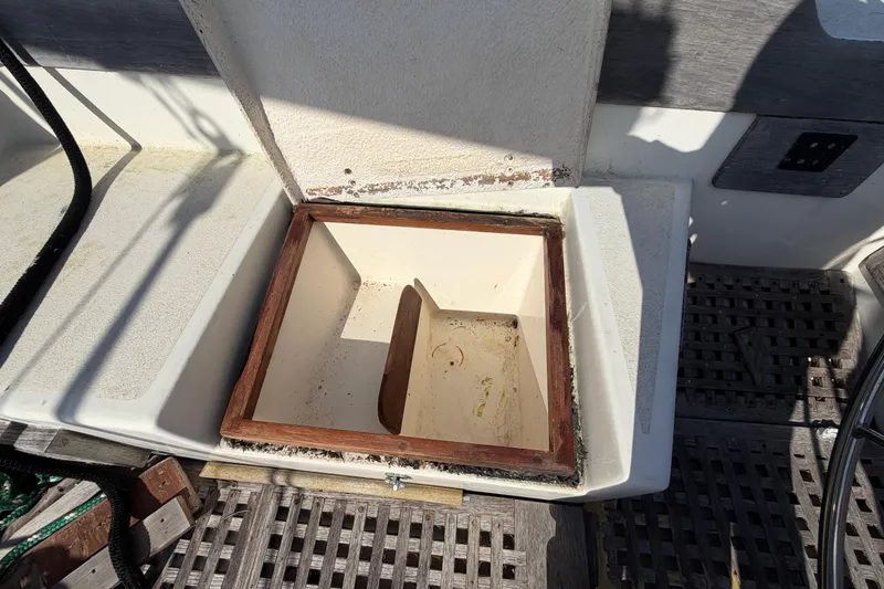 Slide: The Image of Open storage compartment on 1983 Morgan Catilina boat deck, featuring wooden trim. - 65