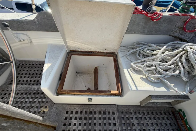 Slide: The Image of Open storage compartment on 1983 Morgan Catilina boat deck with coiled ropes. - 68