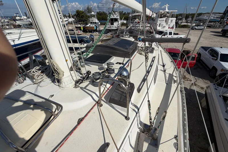 Slide: The Image of 1983 Morgan Catilina sailboat deck with rigging and marina background. - 76