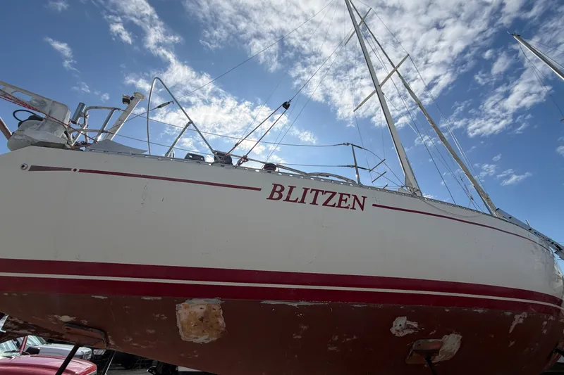 Slide: The Image of 1983 Morgan Catilina sailboat named Blitzen, docked under a blue sky. - 8