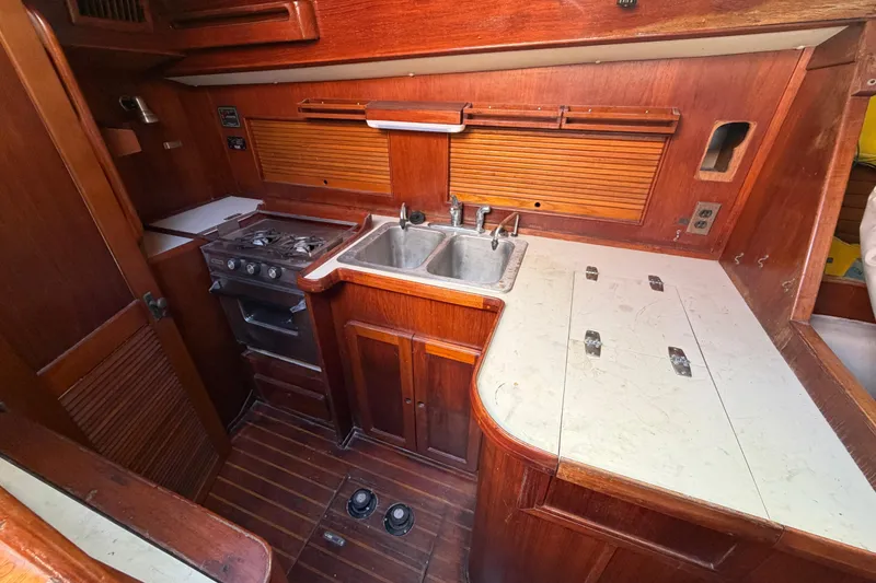 Slide: The Image of 1983 Morgan Catilina yacht kitchen with wooden cabinetry, stove, and sink. - 82