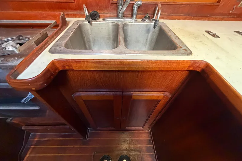 Slide: The Image of Wooden kitchen area with double sink in 1983 Morgan Catilina boat. - 86