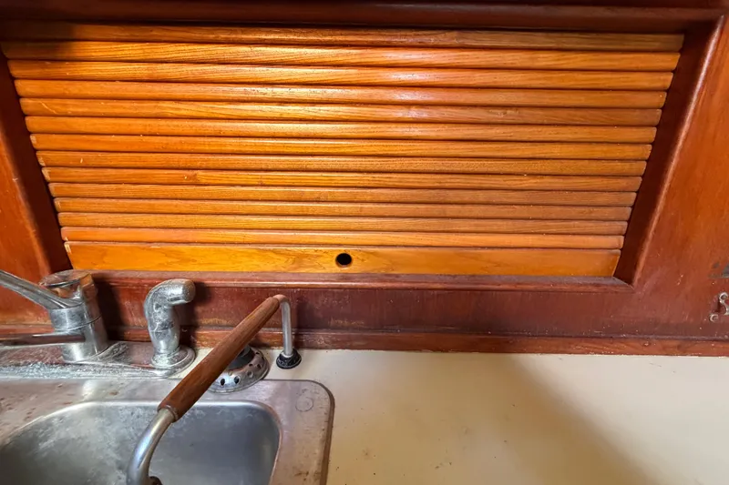 Slide: The Image of Wooden cabinet and metal sink in 1983 Morgan Catilina boat kitchen. - 88