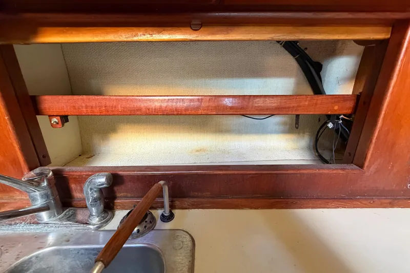 Slide: The Image of 1983 Morgan Catilina interior with wooden cabinetry and metal sink fixtures. - 89