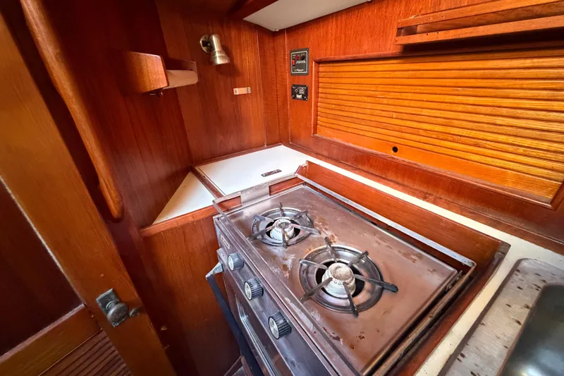 Slide: The Image of 1983 Morgan Catilina yacht kitchen with wooden cabinetry and gas stove. - 90