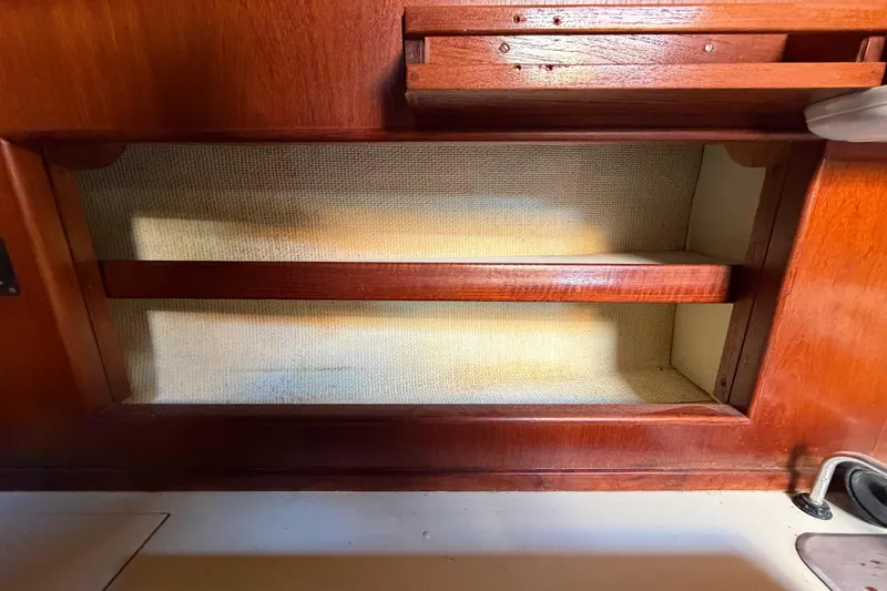 Slide: The Image of Wooden interior shelf in 1983 Morgan Catilina boat, featuring a simple, classic design. - 93