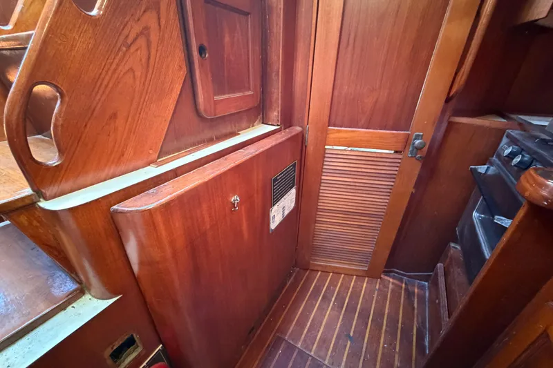 Slide: The Image of 1983 Morgan Catilina yacht interior with wooden cabinetry and flooring. - 94