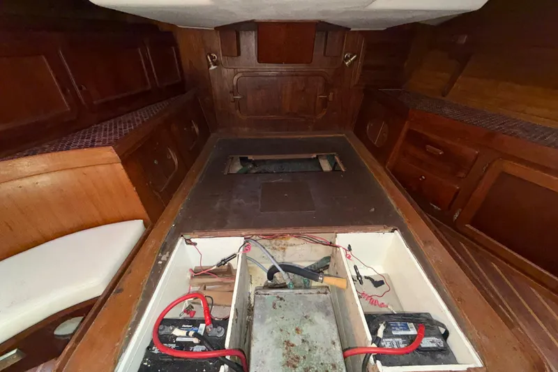 Slide: The Image of Interior of 1983 Morgan Catilina boat with wooden cabinetry and battery compartment. - 98